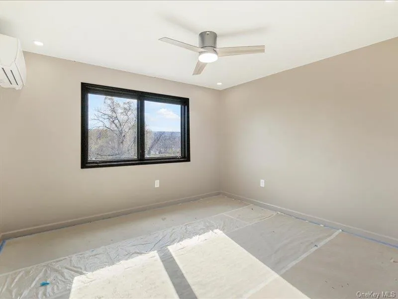 Spare room featuring ceiling fan, a wall mounted air conditioner, and recessed lighting Spare room featuring ceiling fan, a wall mounted air conditioner, and recessed lighting