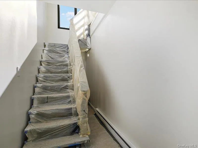 Stairs featuring baseboard heating Stairs featuring baseboard heating