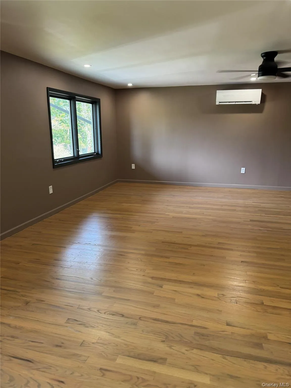 Spare room with light wood-style flooring, ceiling fan, recessed lighting, and a wall unit AC Spare room with light wood-style flooring, ceiling fan, recessed lighting, and a wall unit AC