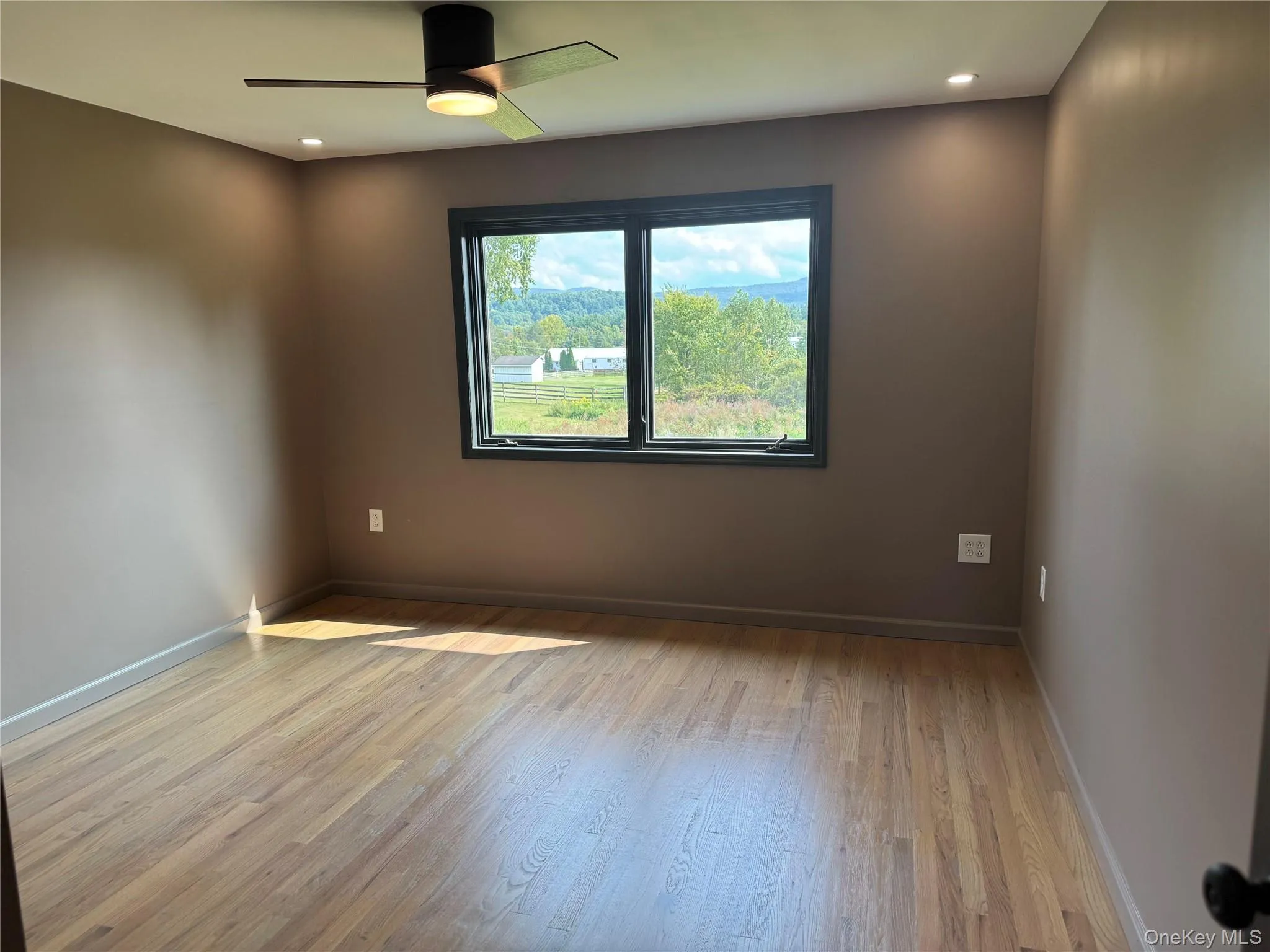 Empty room featuring light wood-style flooring, recessed lighting, and a ceiling fan Empty room featuring light wood-style flooring, recessed lighting, and a ceiling fan