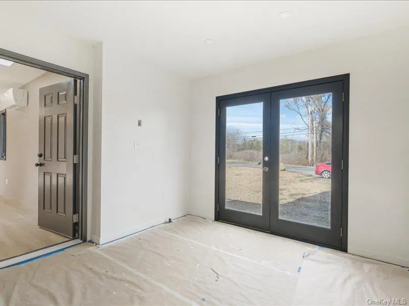 Entryway with french doors and a wall mounted air conditioner Entryway with french doors and a wall mounted air conditioner
