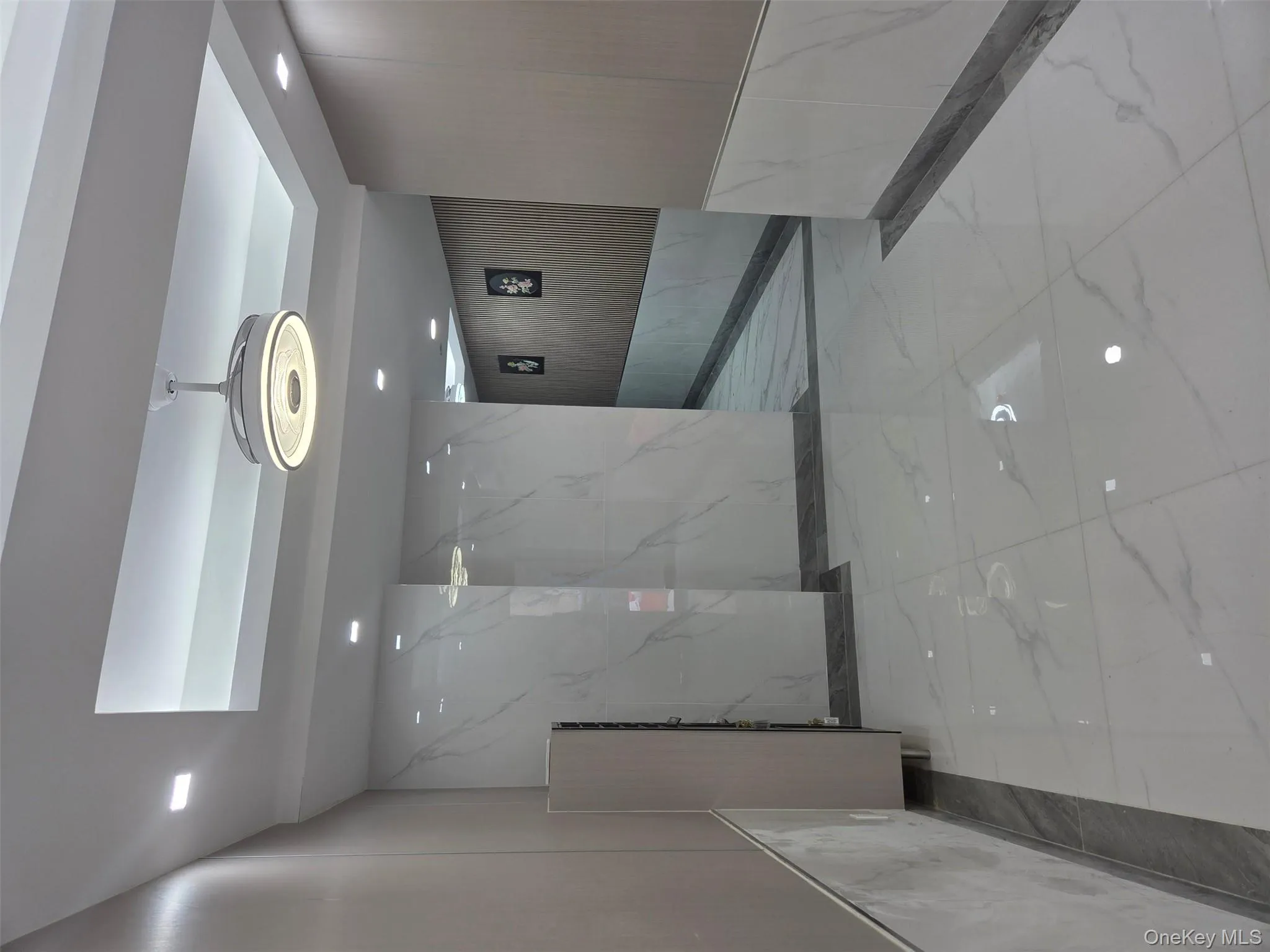 Community lobby featuring recessed lighting and wood walls Community lobby featuring recessed lighting and wood walls