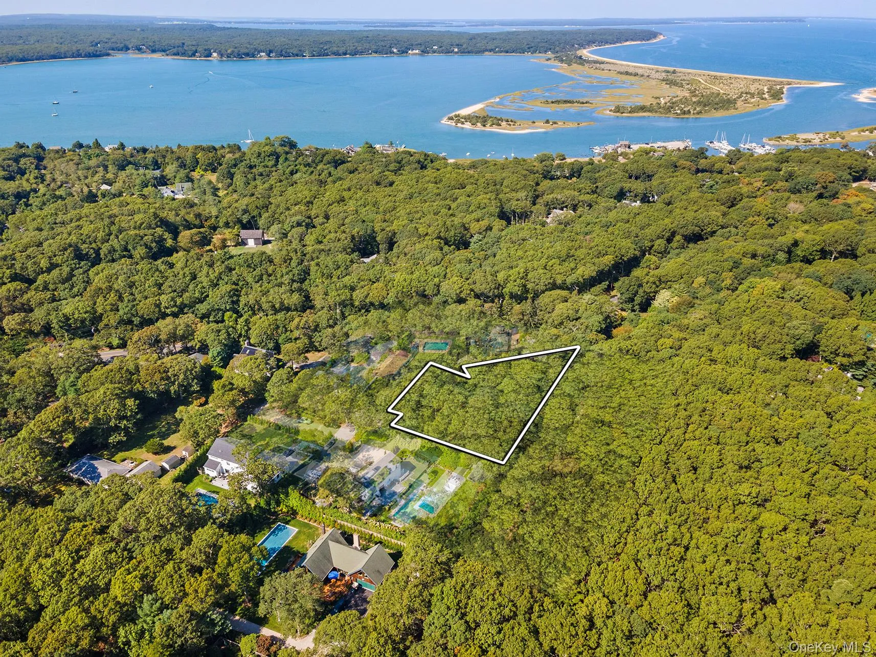 Aerial overview of property's location featuring property boundaries highlighted and a nearby body of water Aerial overview of property's location featuring property boundaries highlighted and a nearby body of water