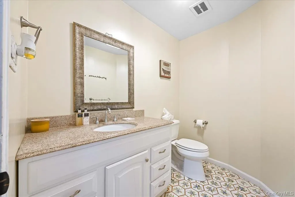 Bathroom with vanity and light tile patterned floors Bathroom with vanity and light tile patterned floors
