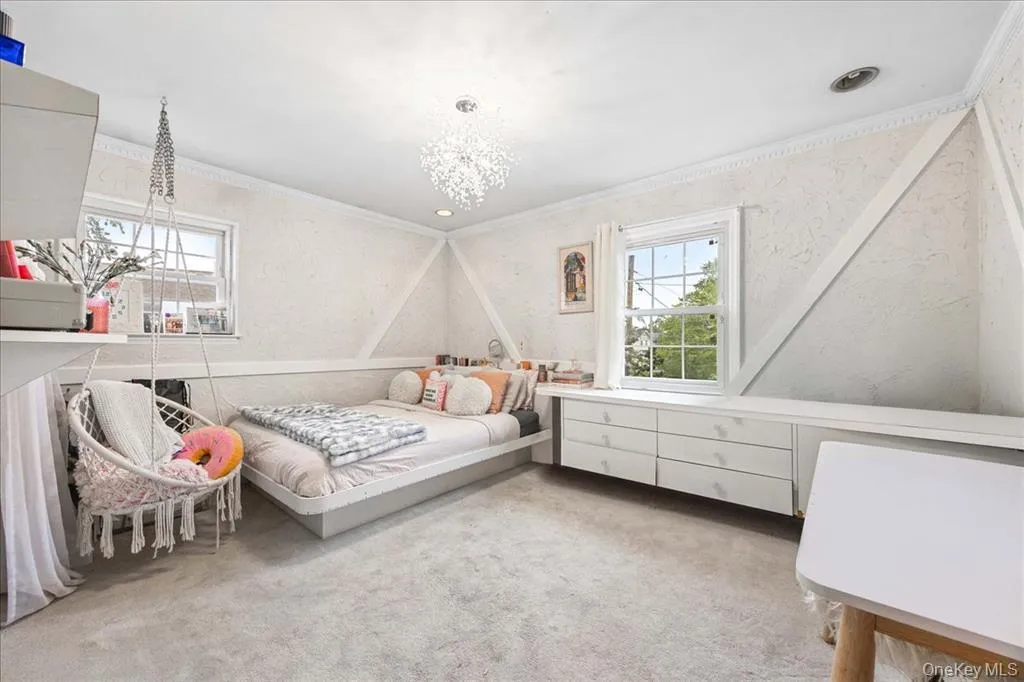 Bedroom featuring crown molding and carpet Bedroom featuring crown molding and carpet