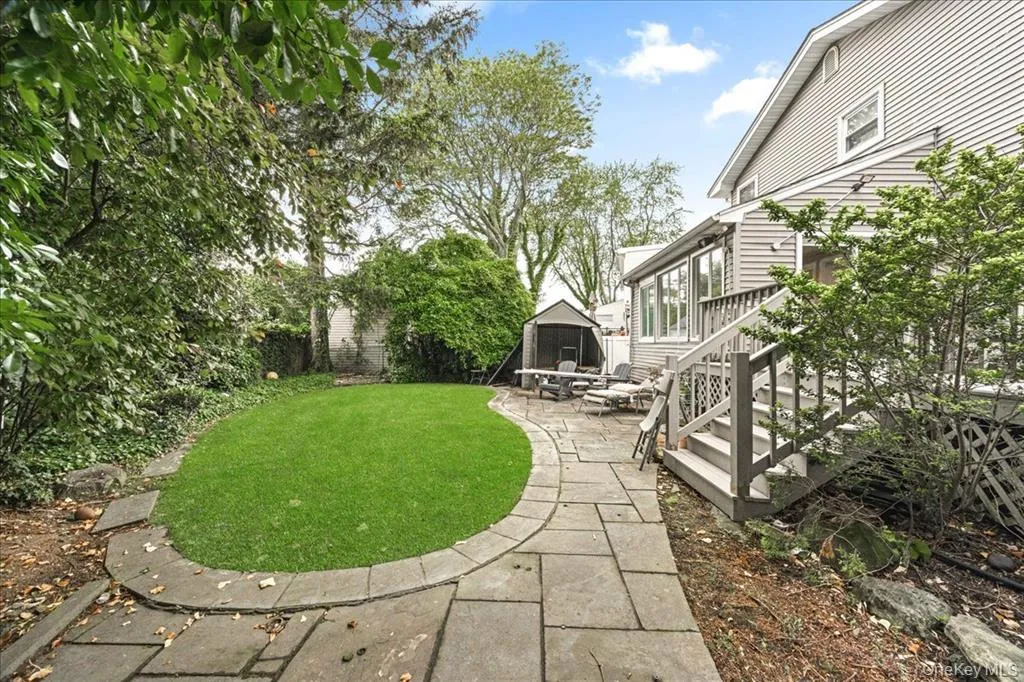Fenced backyard featuring a patio area and a storage shed Fenced backyard featuring a patio area and a storage shed
