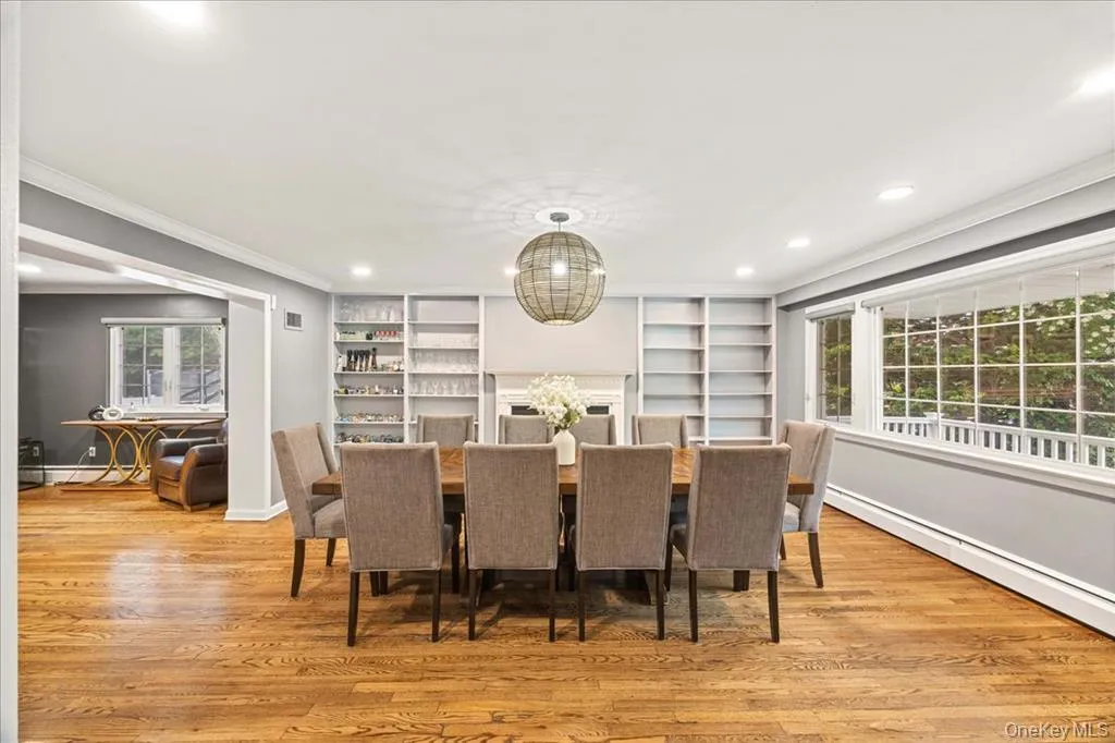 Dining space with healthy amount of natural light, ornamental molding, light wood-style floors, recessed lighting, and a baseboard heating unit Dining space with healthy amount of natural light, ornamental molding, light wood-style floors, recessed lighting, and a baseboard heating unit