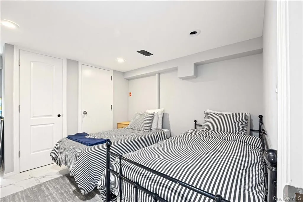 Bedroom with light marble finish flooring and recessed lighting Bedroom with light marble finish flooring and recessed lighting