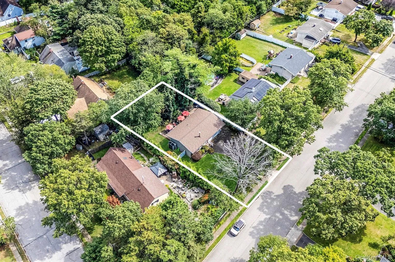 Aerial view of residential area featuring property boundaries highlighted Aerial view of residential area featuring property boundaries highlighted