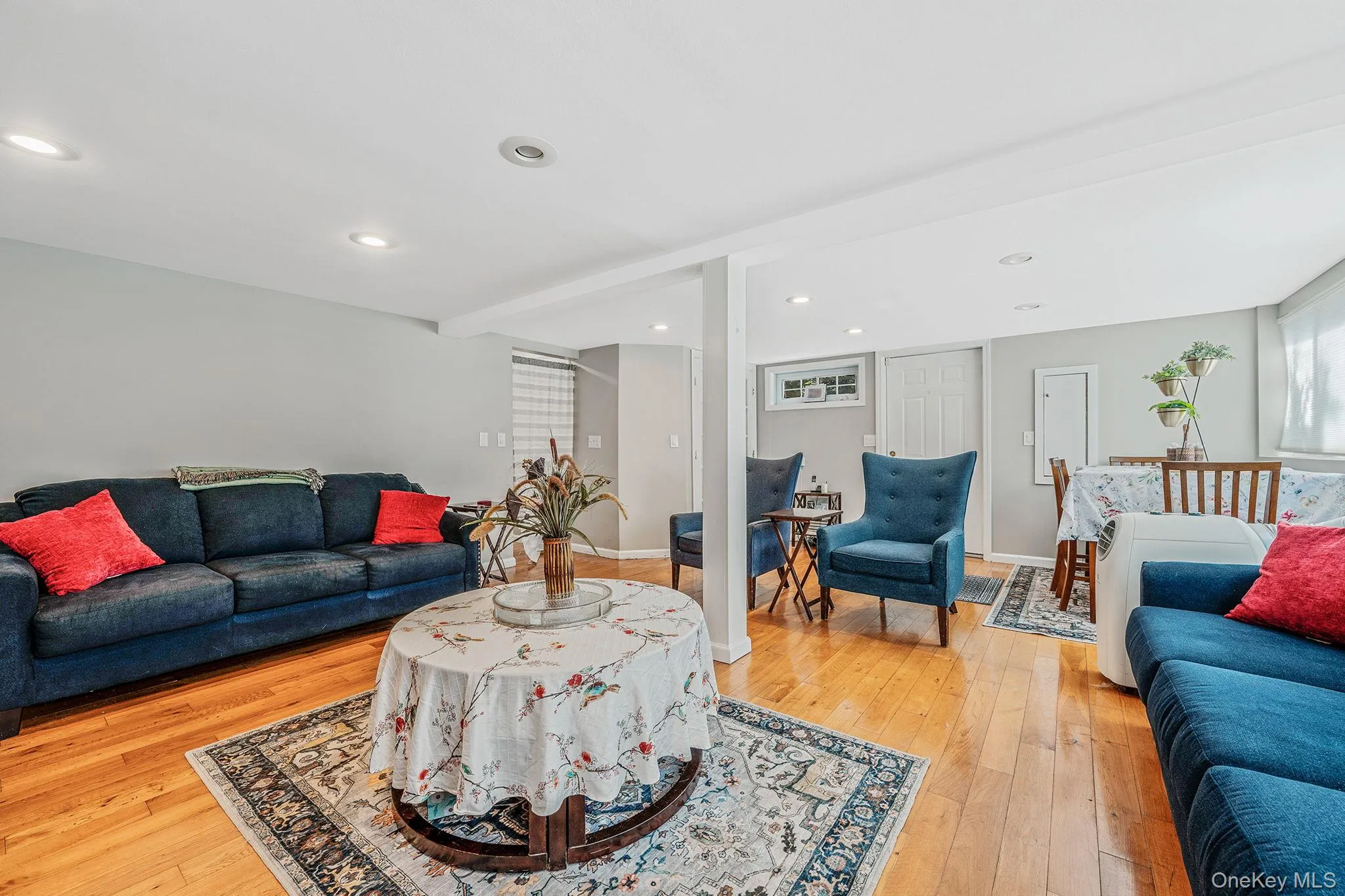 Living room with light wood-style flooring and recessed lighting Living room with light wood-style flooring and recessed lighting