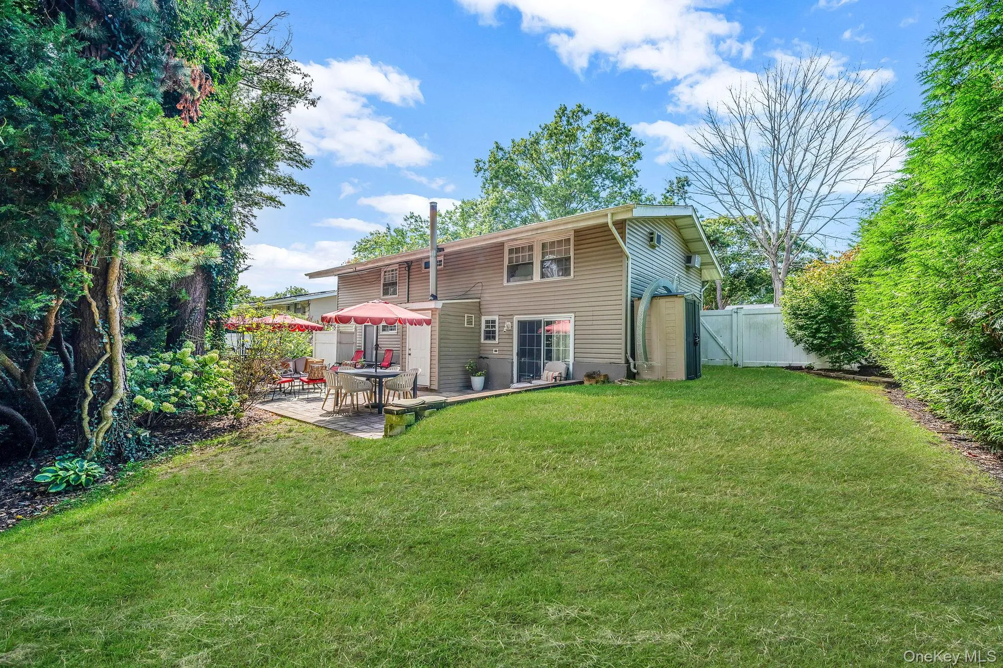 Rear view of property with a fenced backyard, a patio area, and a gate Rear view of property with a fenced backyard, a patio area, and a gate