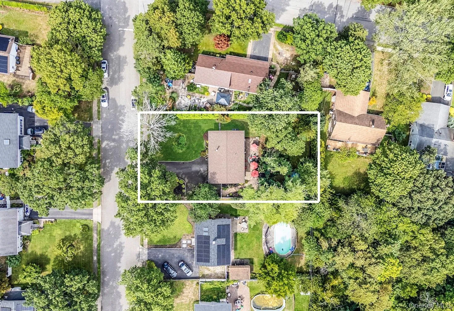 Aerial perspective of suburban area featuring property boundaries highlighted Aerial perspective of suburban area featuring property boundaries highlighted