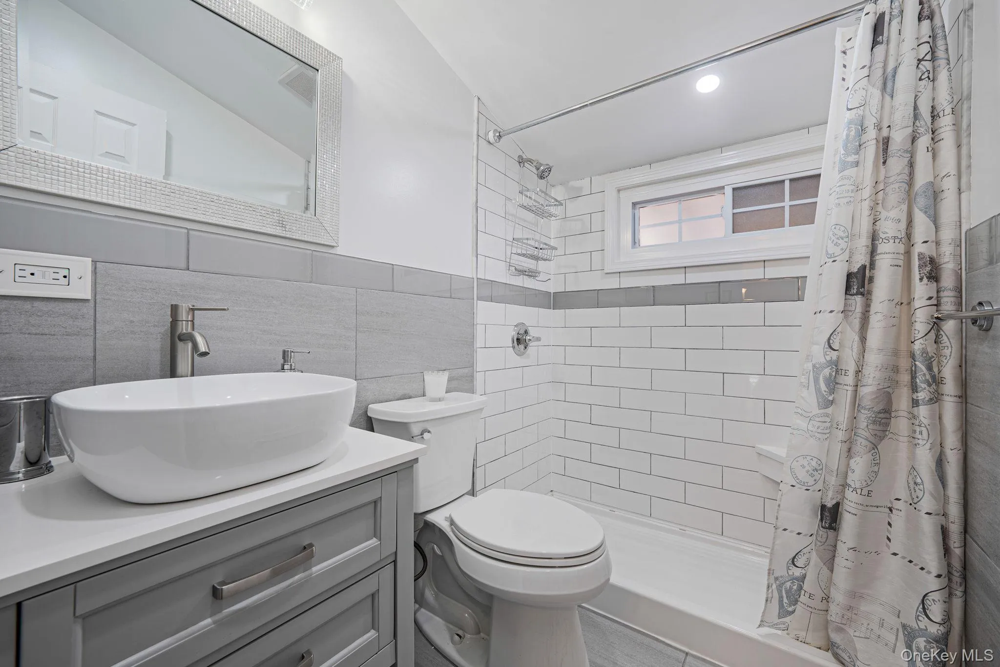 Full bath featuring vanity, a stall shower, tile walls, and recessed lighting Full bath featuring vanity, a stall shower, tile walls, and recessed lighting
