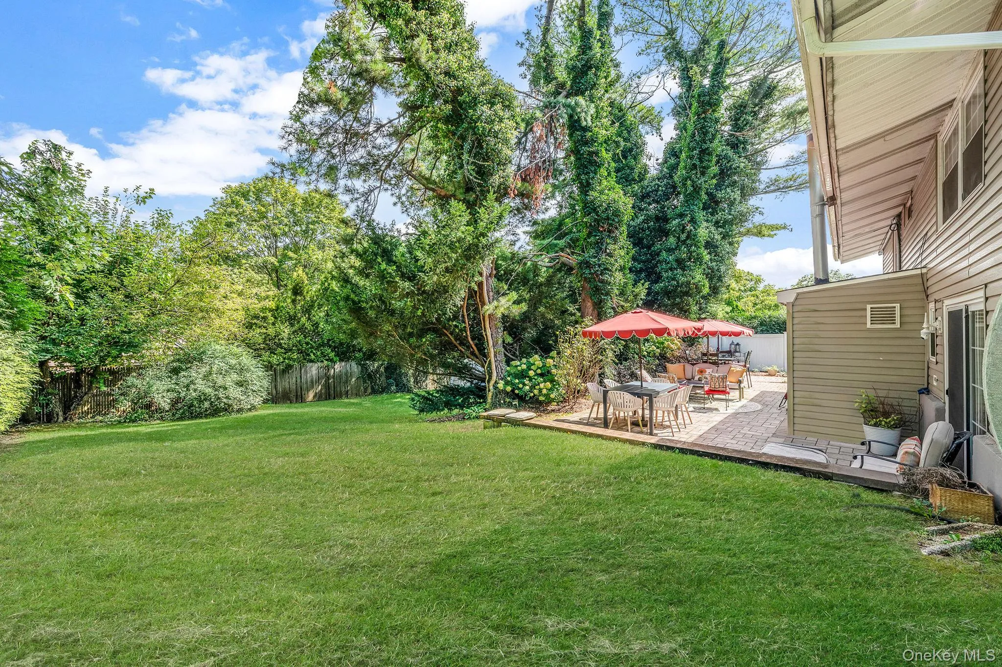View of yard with a patio area and a wooden deck View of yard with a patio area and a wooden deck