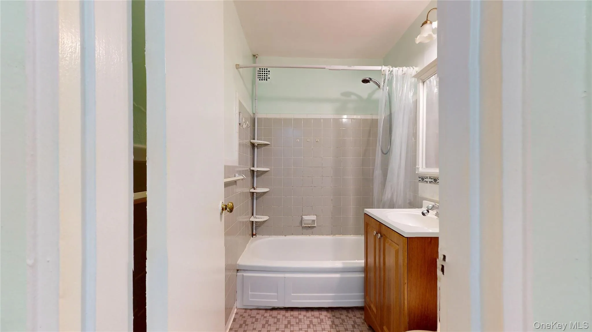 Bathroom featuring shower / bath combo and vanity Bathroom featuring shower / bath combo and vanity