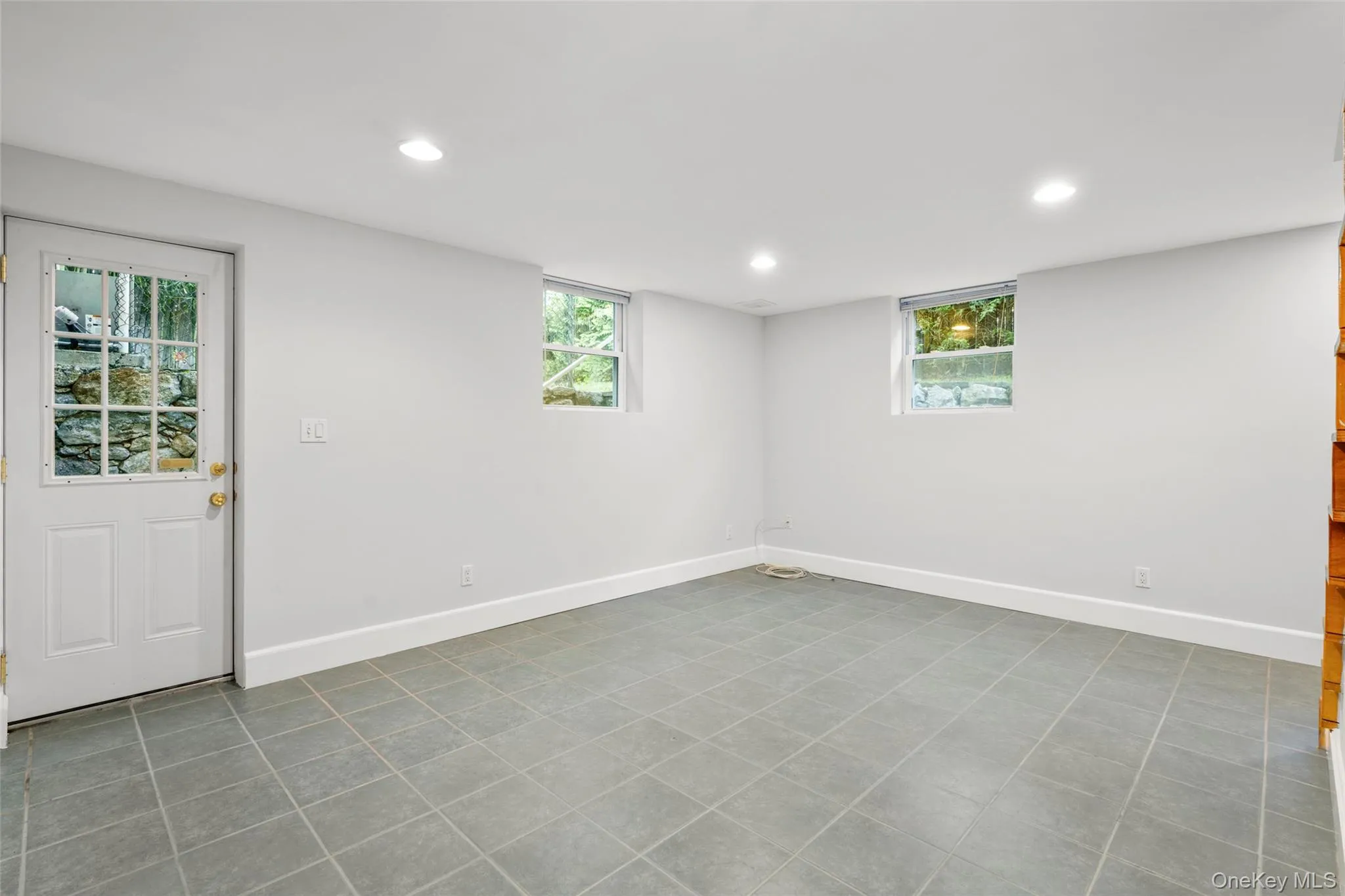 Basement featuring recessed lighting and light tile patterned floors Basement featuring recessed lighting and light tile patterned floors