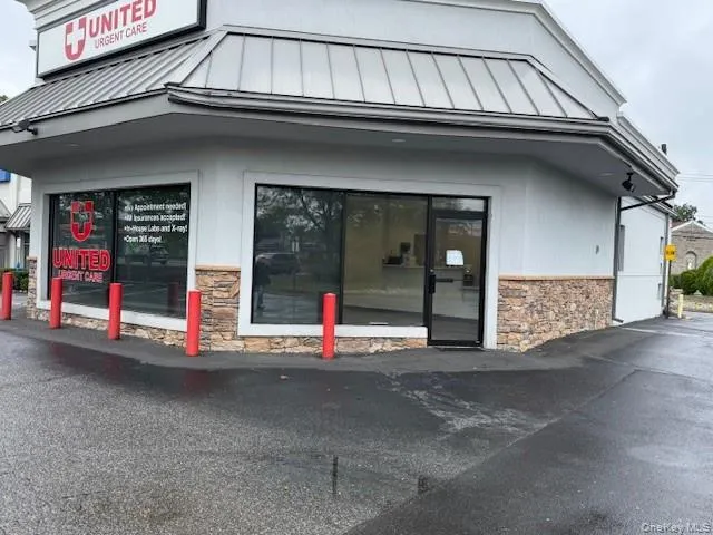 Entrance to property featuring stone siding and a metal roof Entrance to property featuring stone siding and a metal roof