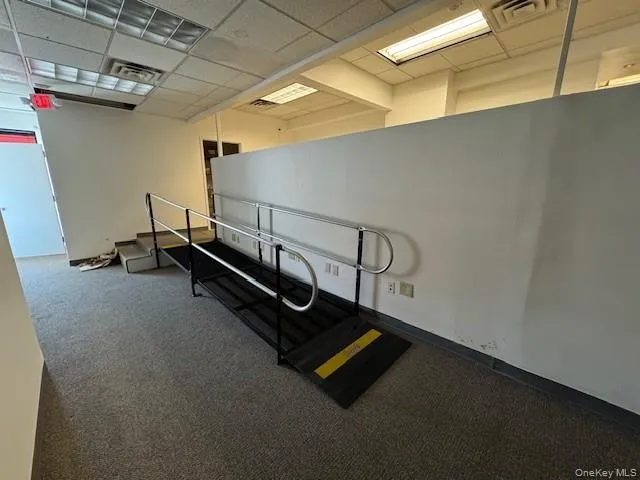 Exercise area with a paneled ceiling and carpet Exercise area with a paneled ceiling and carpet