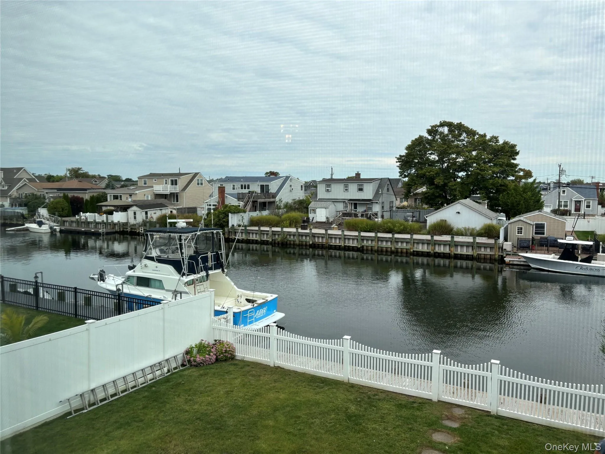 Dock area with a residential view and a water view Dock area with a residential view and a water view