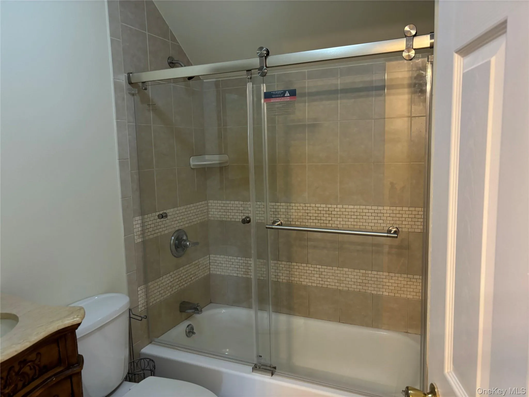 Bathroom with enclosed tub / shower combo and vanity Bathroom with enclosed tub / shower combo and vanity