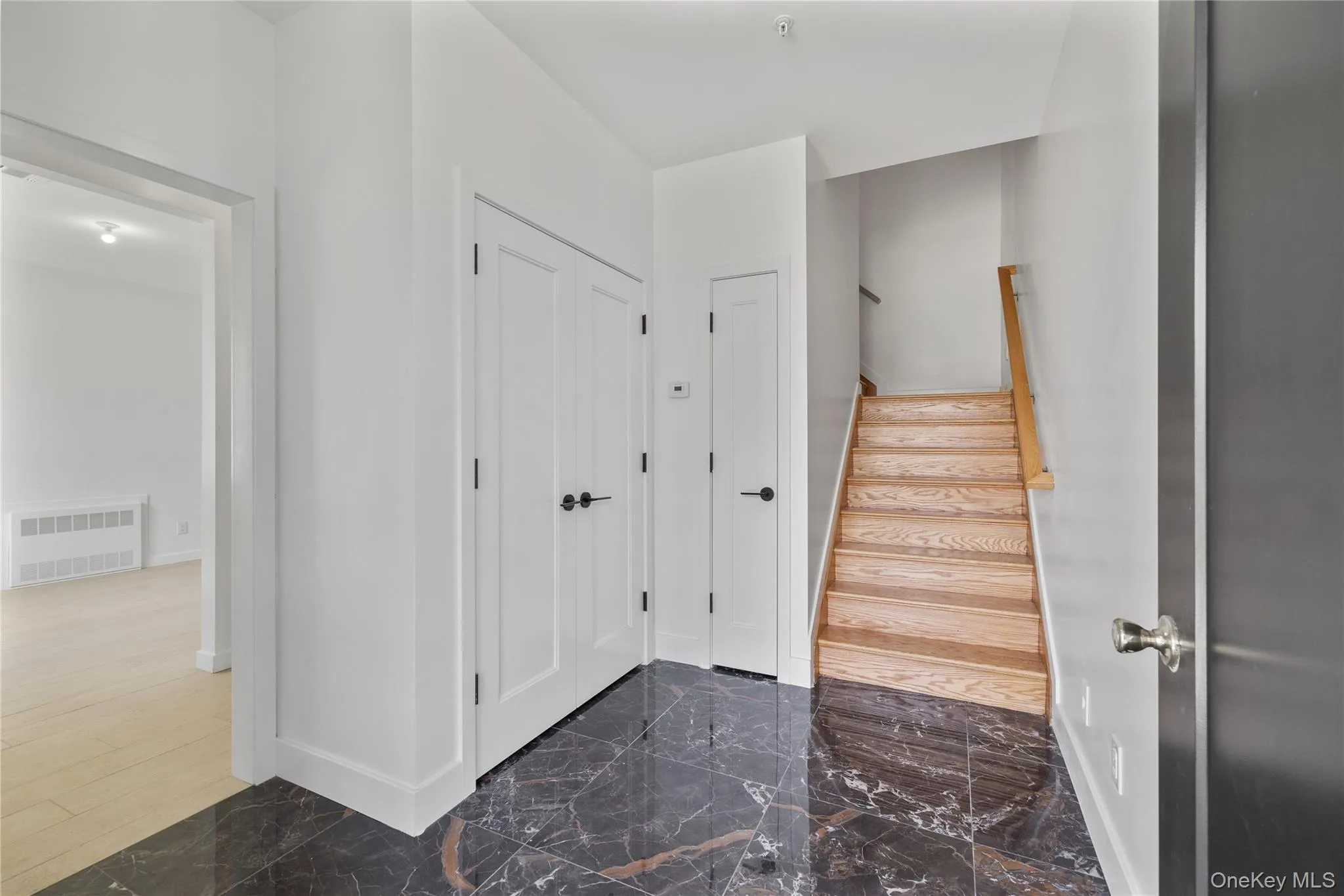 Stairs featuring visible vents, marble finish floor, and baseboards Stairs featuring visible vents, marble finish floor, and baseboards