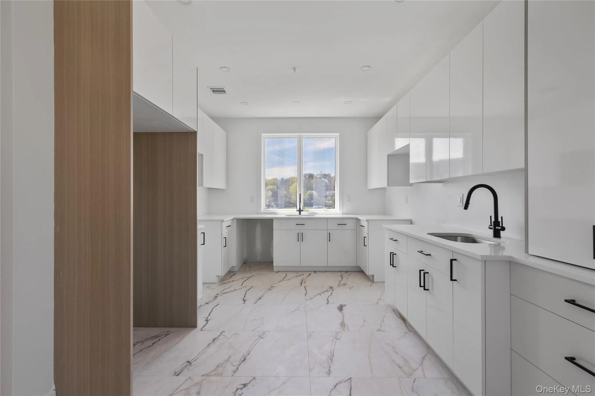 Kitchen with modern cabinets, visible vents, marble finish floor, and a sink Kitchen with modern cabinets, visible vents, marble finish floor, and a sink
