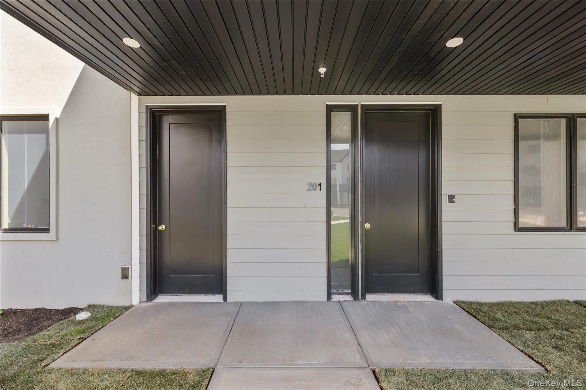 Doorway to property with stucco siding and elevator Doorway to property with stucco siding and elevator
