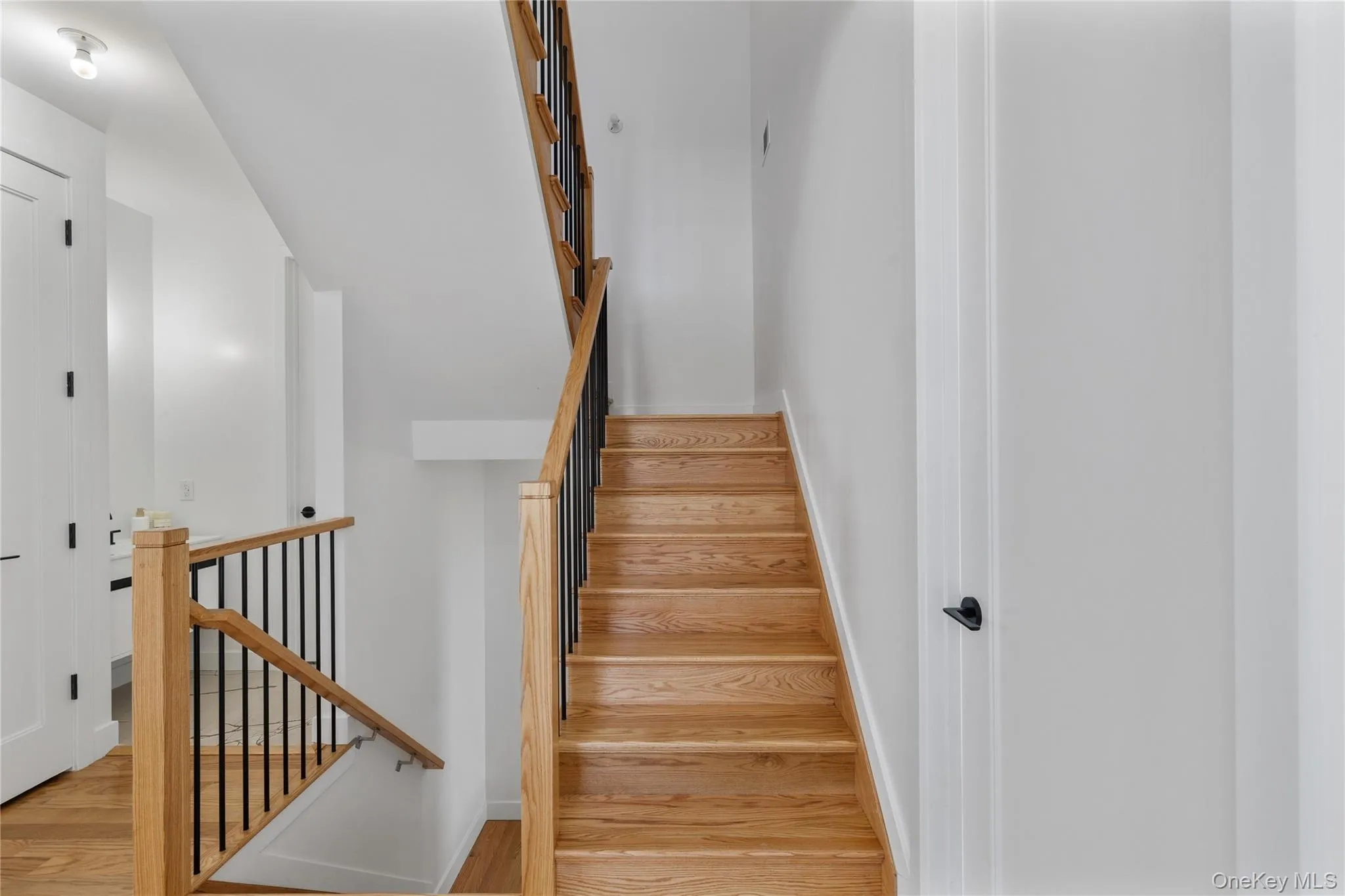 Staircase with baseboards and wood finished floors Staircase with baseboards and wood finished floors