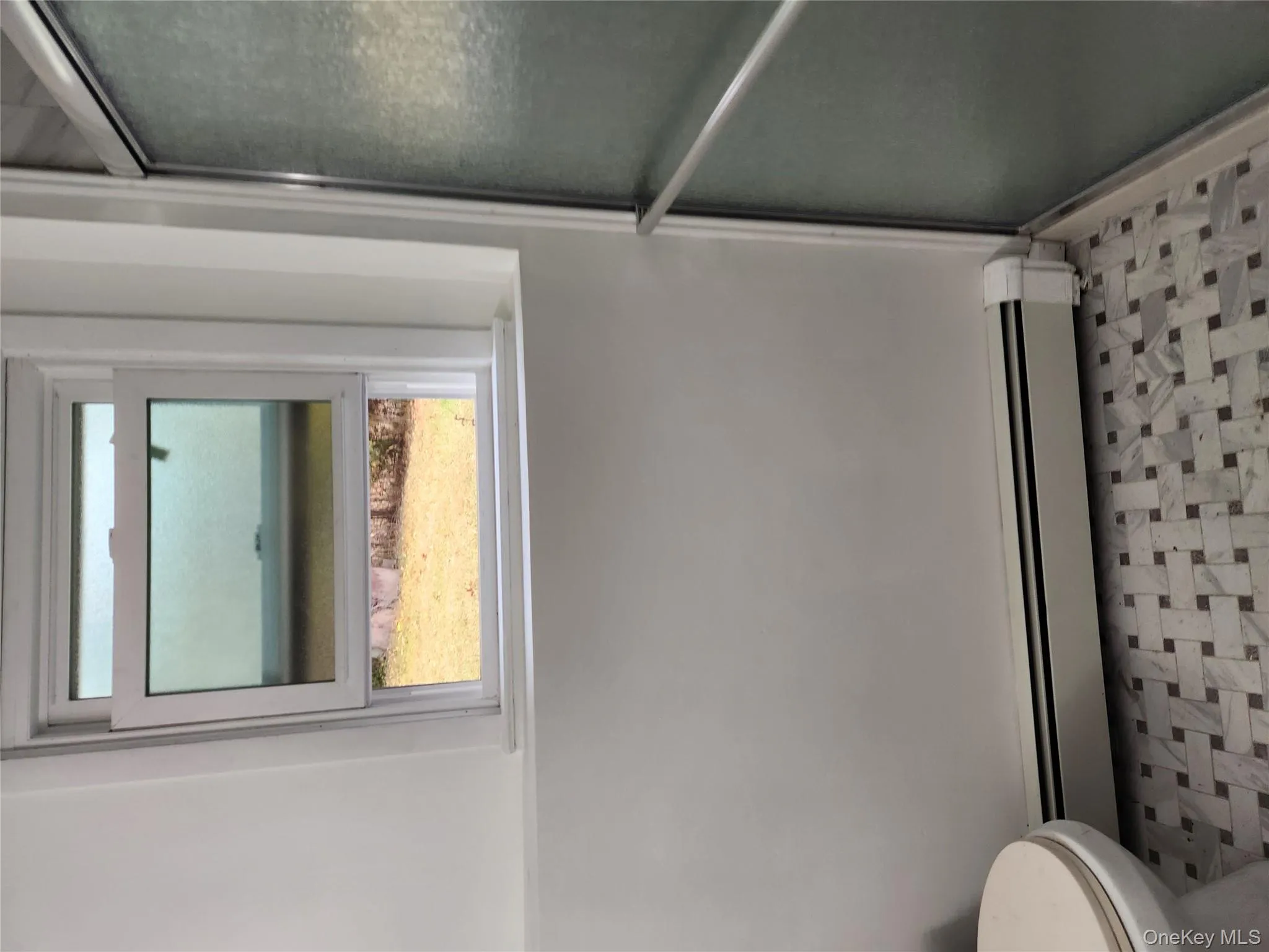 Full bath with baseboard heating and a shower stall Full bath with baseboard heating and a shower stall