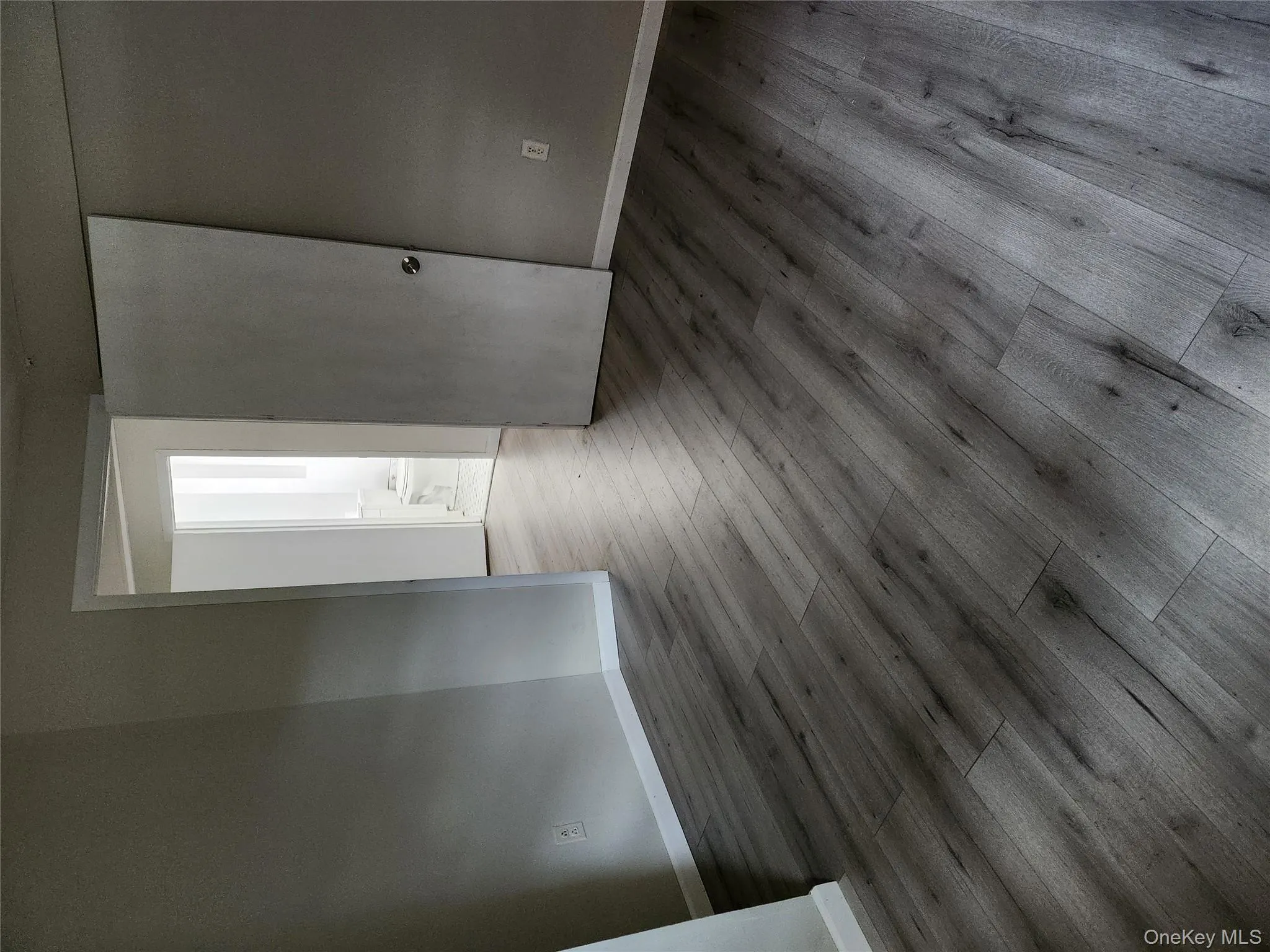 Unfurnished room with wood finished floors and baseboards Unfurnished room with wood finished floors and baseboards