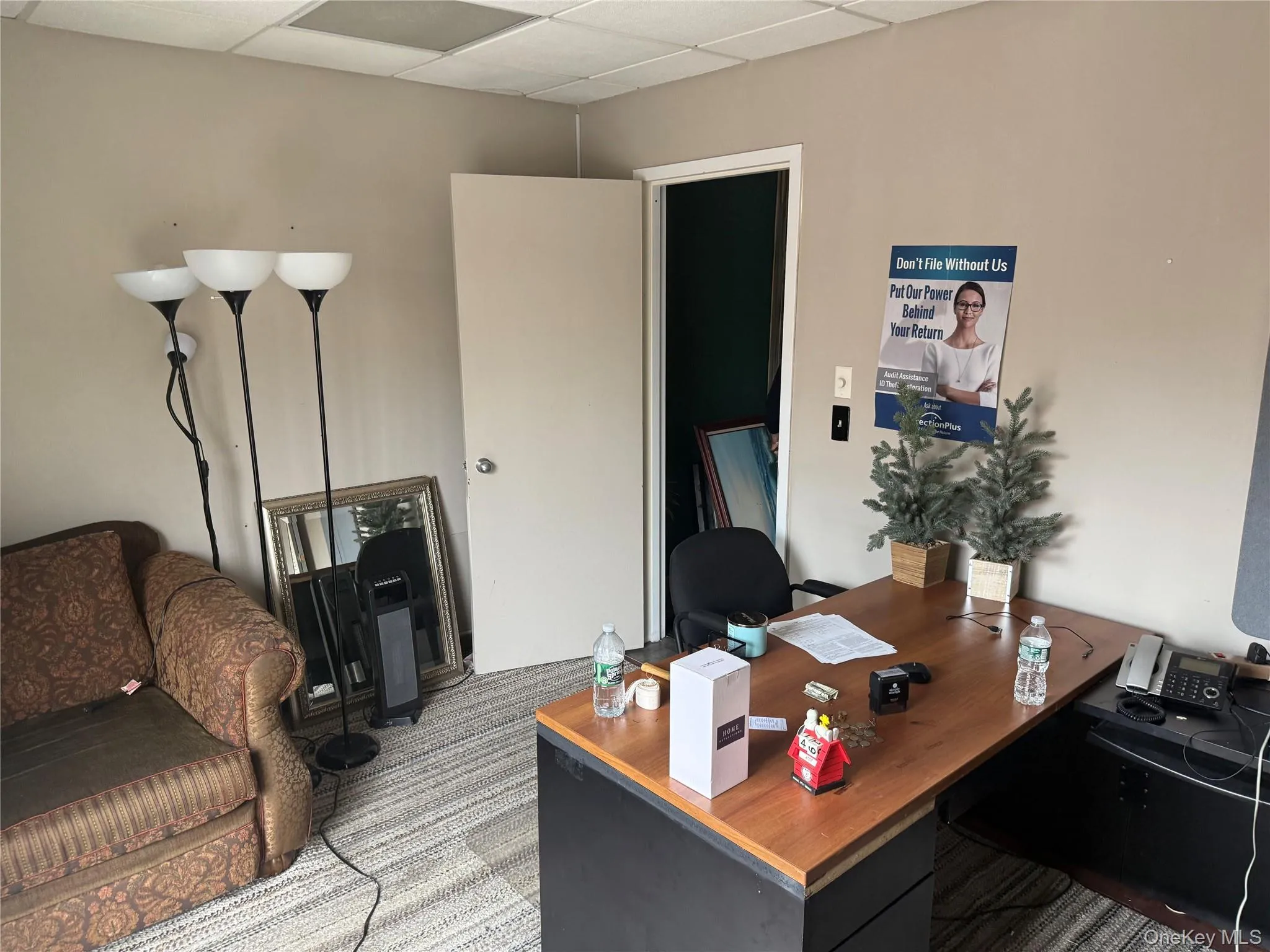 Office area featuring a drop ceiling and carpet floors Office area featuring a drop ceiling and carpet floors