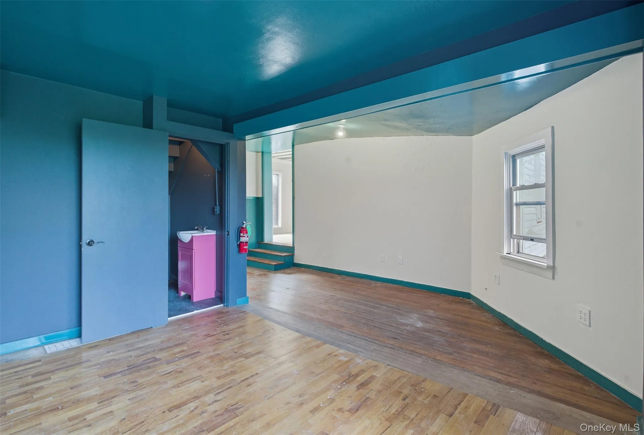 Empty room with wood finished floors and baseboards Empty room with wood finished floors and baseboards