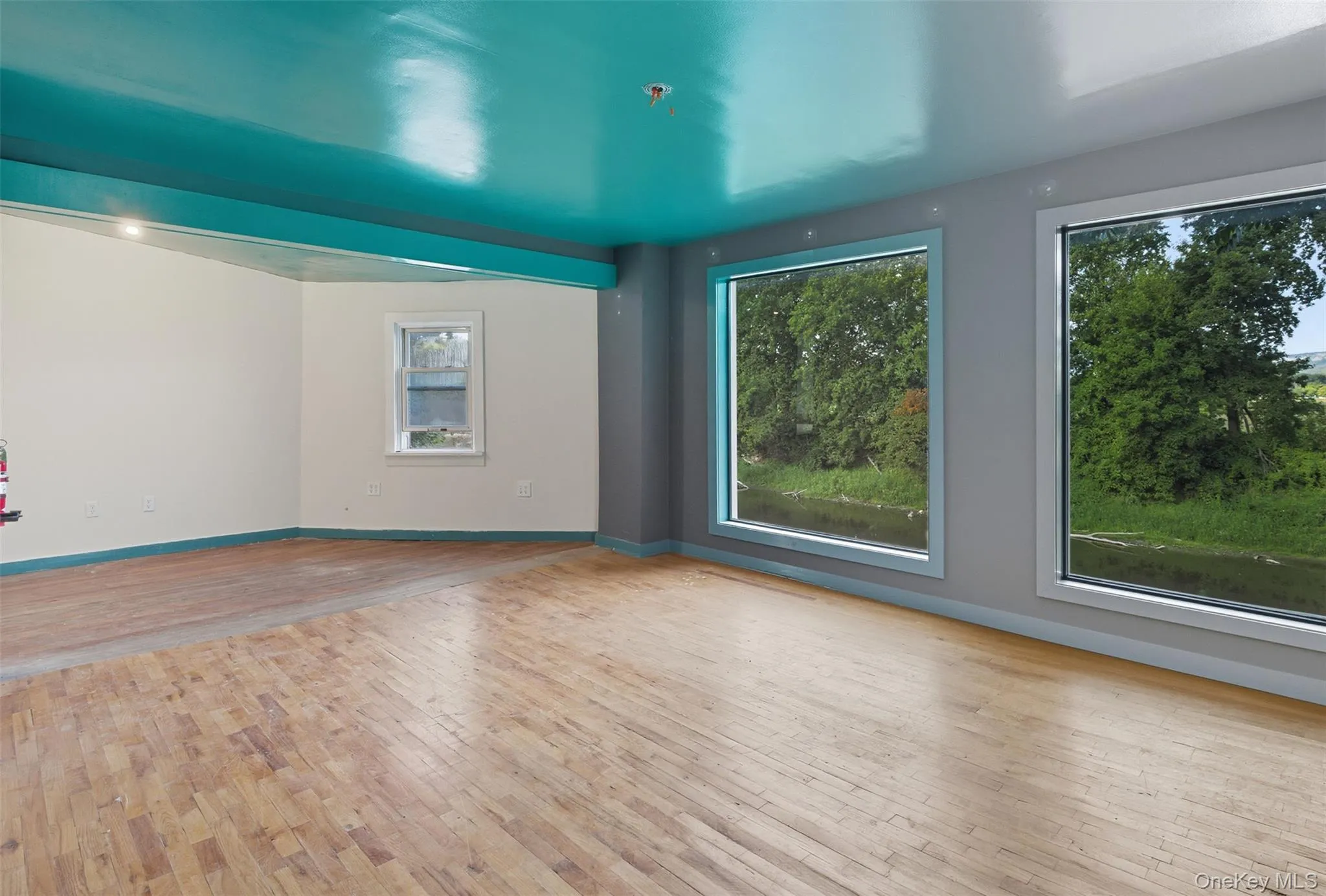 Spare room with light wood-type flooring and baseboards Spare room with light wood-type flooring and baseboards