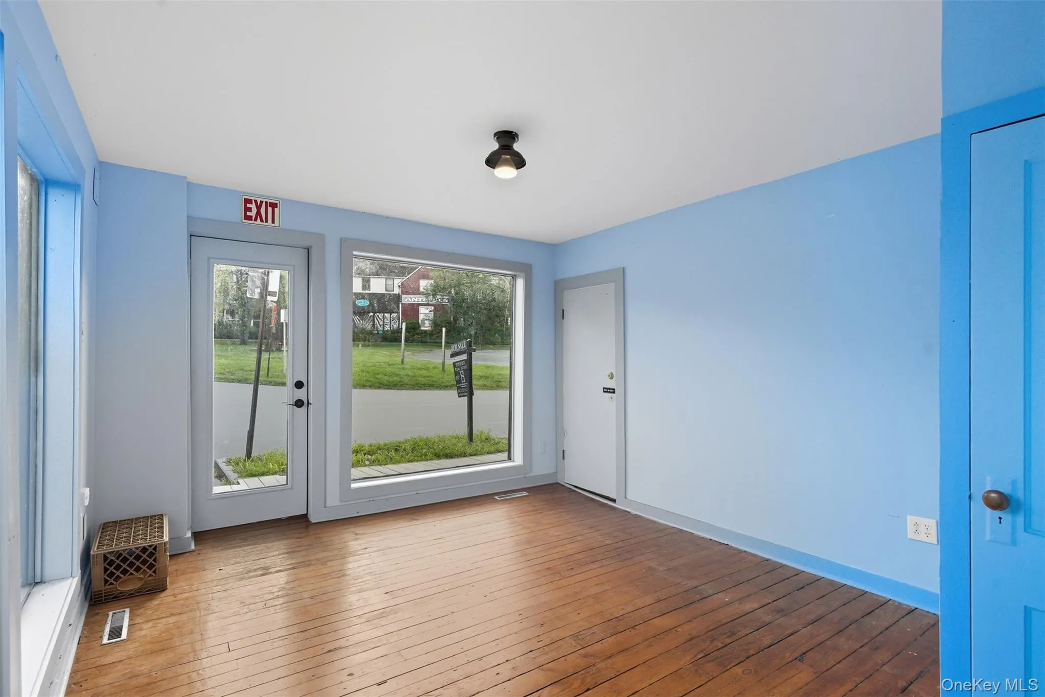 Entryway featuring wood-type flooring and baseboards Entryway featuring wood-type flooring and baseboards