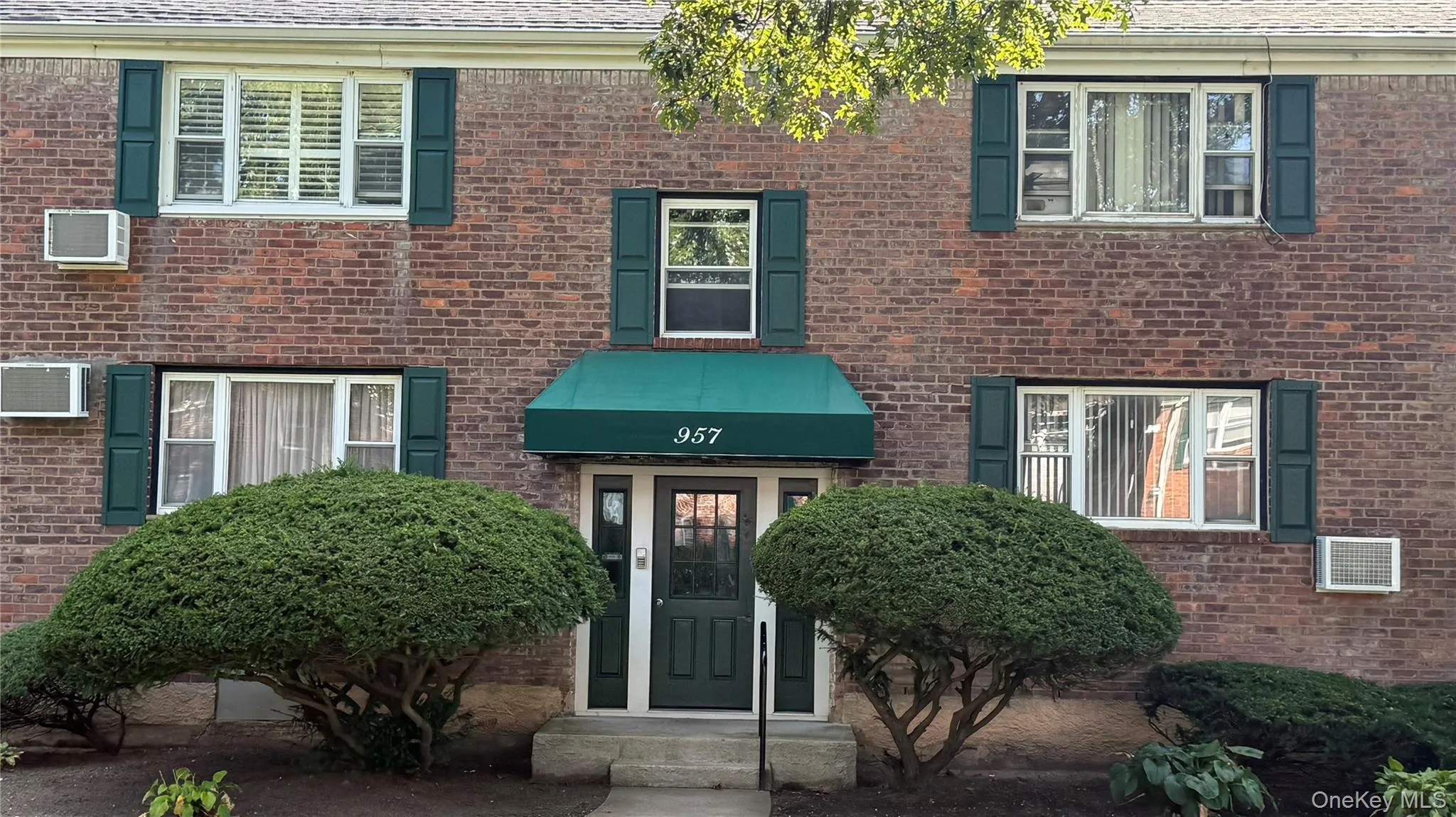 Property entrance featuring brick siding Property entrance featuring brick siding