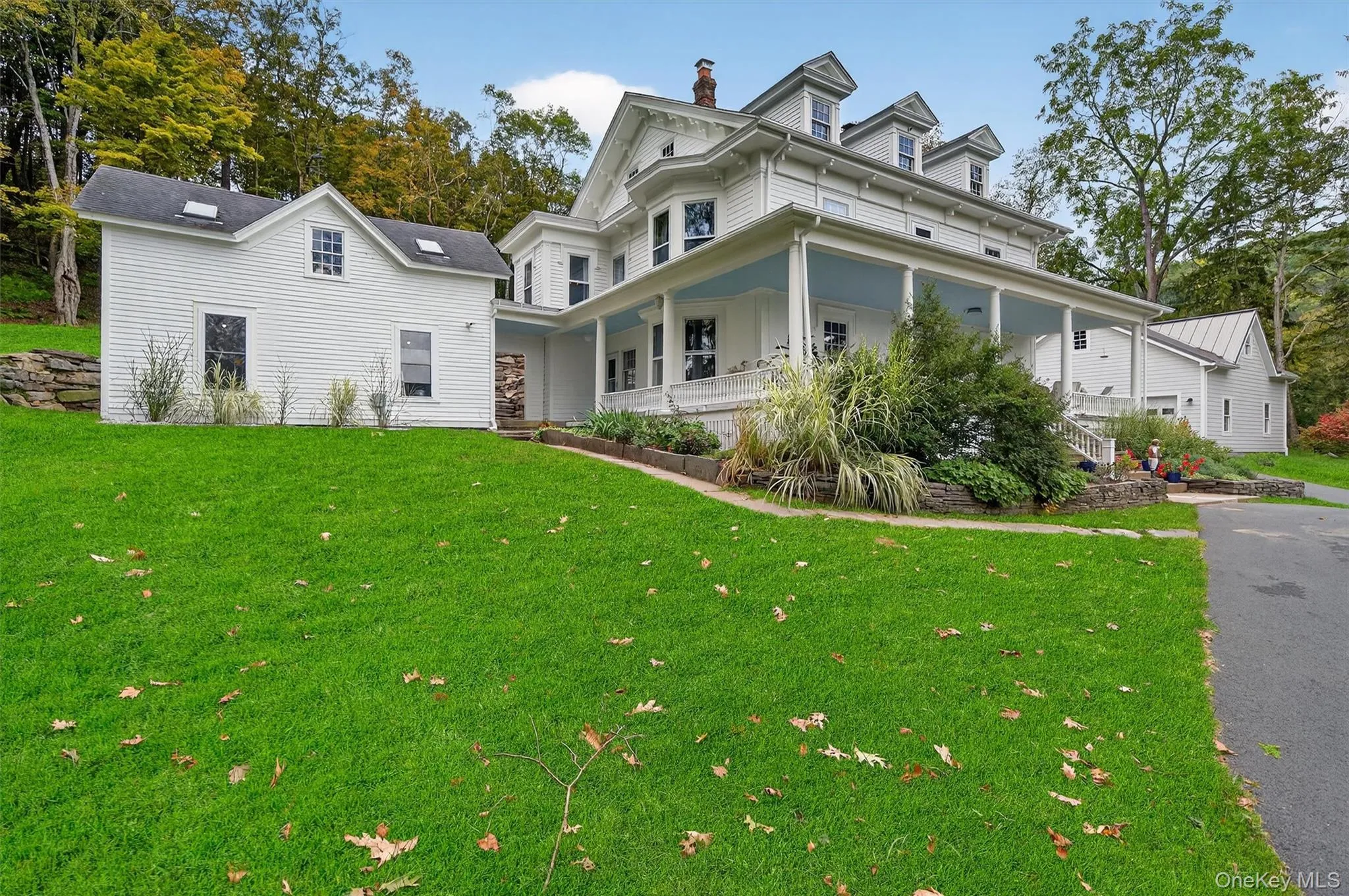 View of front of property with a porch, a chimney, and a front yard View of front of property with a porch, a chimney, and a front yard