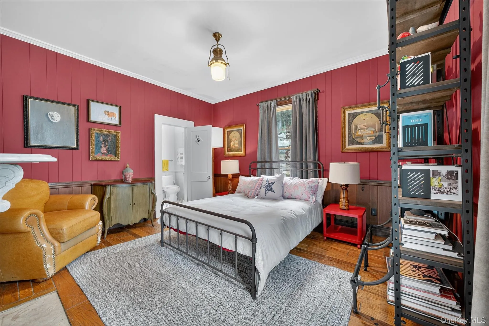 Bedroom with crown molding, wood finished floors, wooden walls, and ensuite bathroom Bedroom with crown molding, wood finished floors, wooden walls, and ensuite bathroom