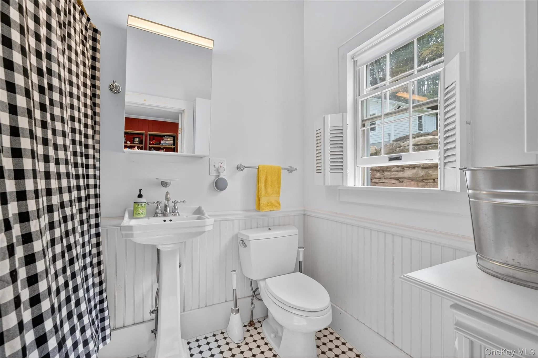 Full bath with toilet and a wainscoted wall Full bath with toilet and a wainscoted wall