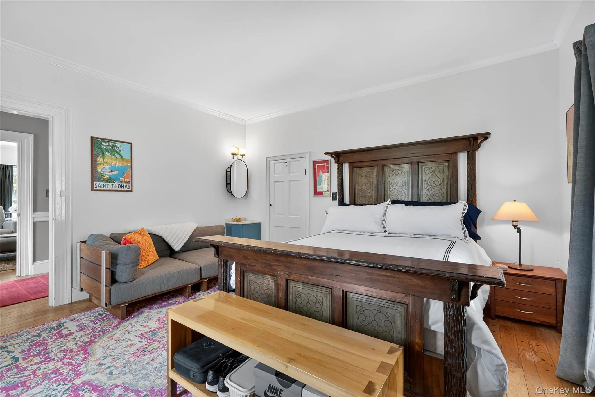 Bedroom featuring crown molding and wood finished floors Bedroom featuring crown molding and wood finished floors