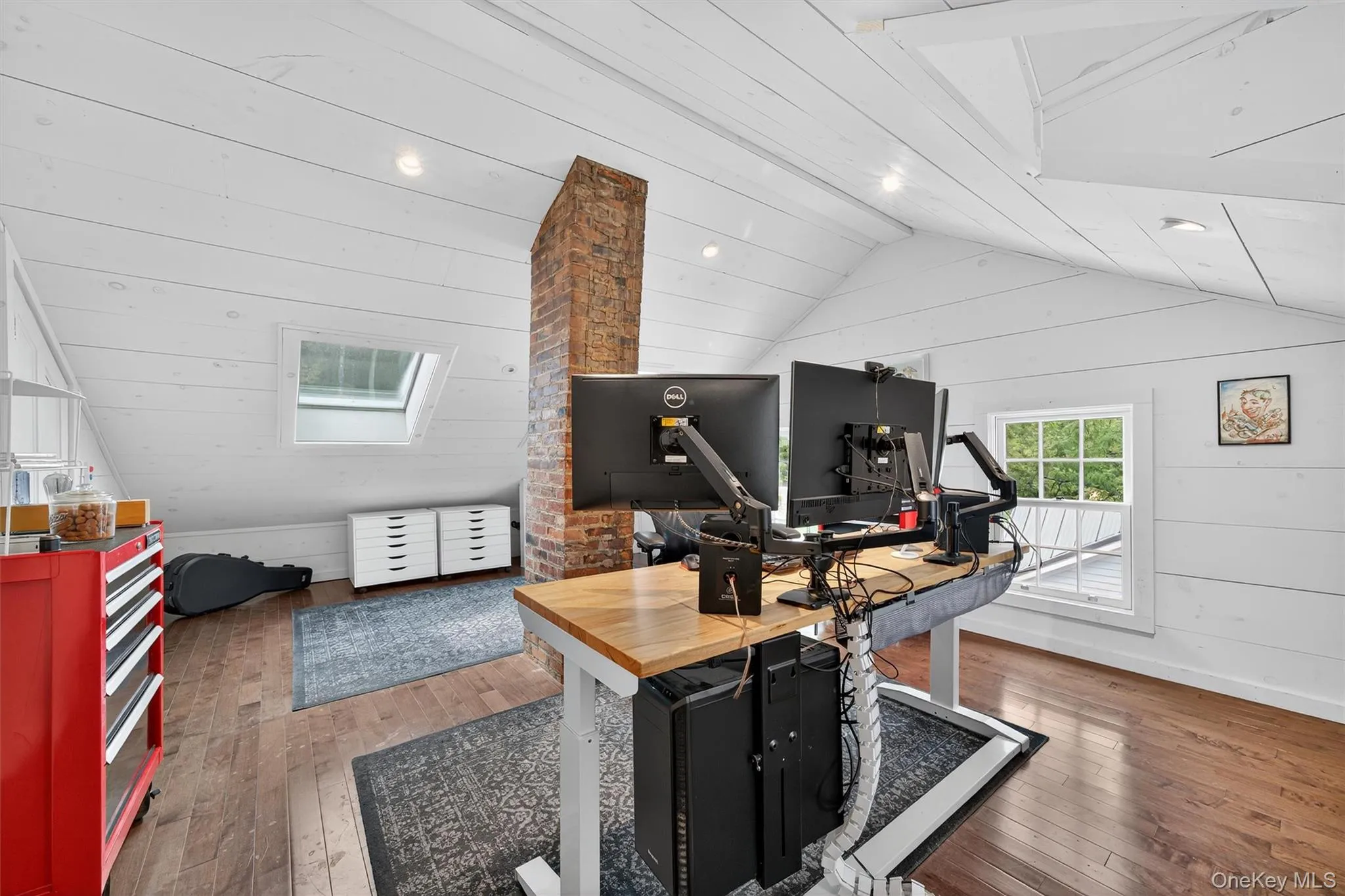 Office area with vaulted ceiling, hardwood / wood-style flooring, wood walls, and recessed lighting Office area with vaulted ceiling, hardwood / wood-style flooring, wood walls, and recessed lighting