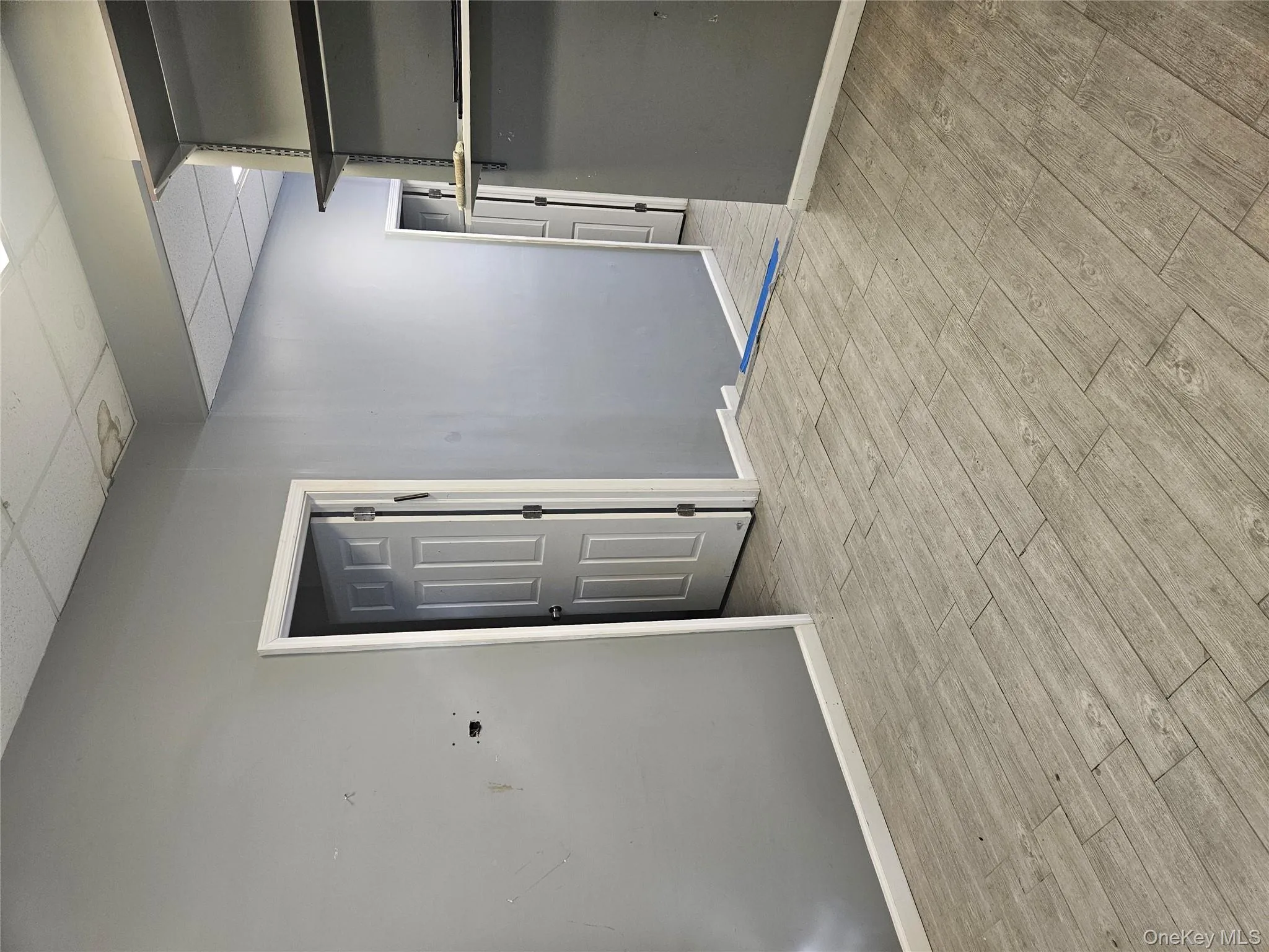 Unfurnished room featuring a paneled ceiling and light wood finished floors Unfurnished room featuring a paneled ceiling and light wood finished floors