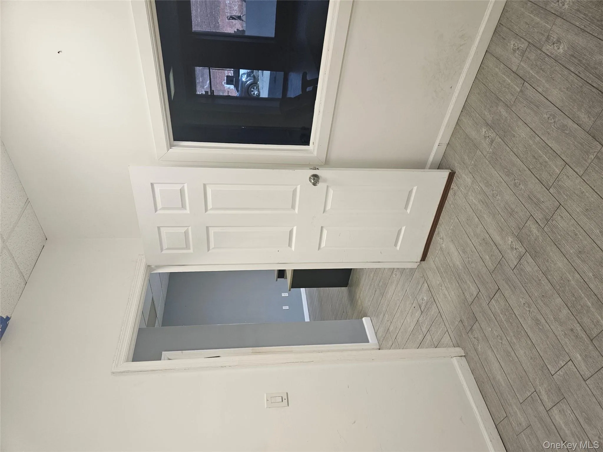 Unfurnished room with a drop ceiling and light wood-type flooring Unfurnished room with a drop ceiling and light wood-type flooring