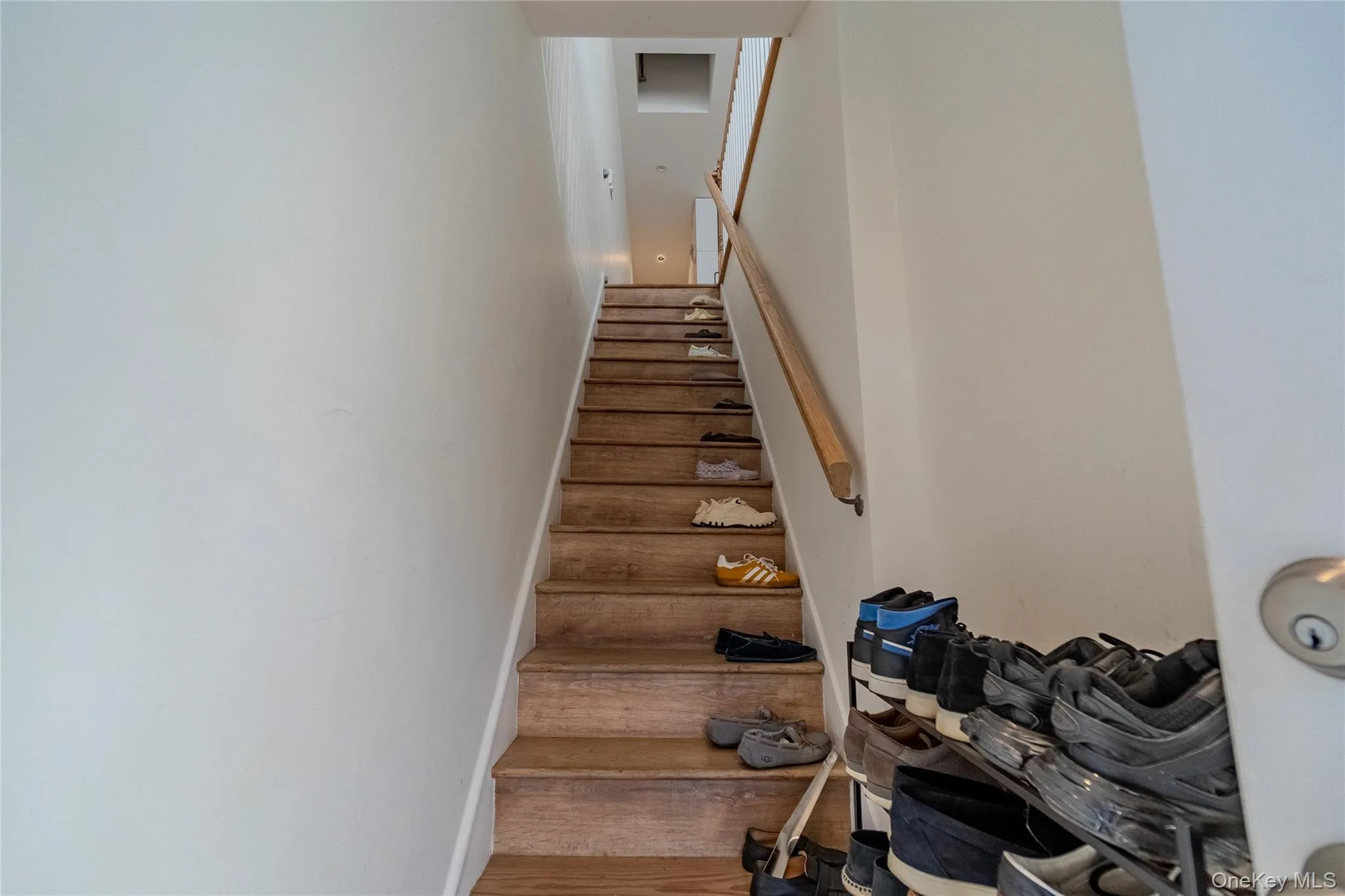 Staircase with wood finished floors and baseboards Staircase with wood finished floors and baseboards