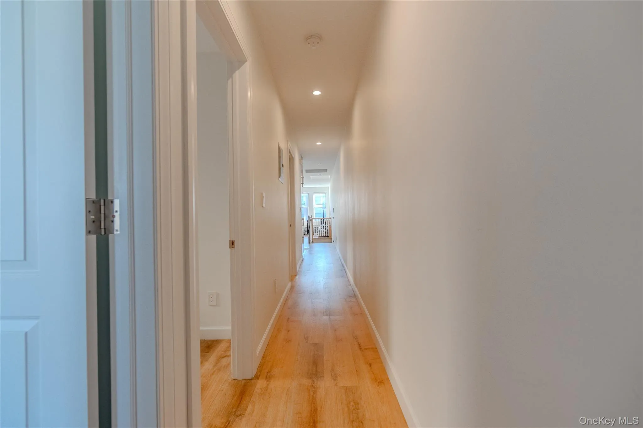 Corridor with light wood-style flooring and recessed lighting Corridor with light wood-style flooring and recessed lighting