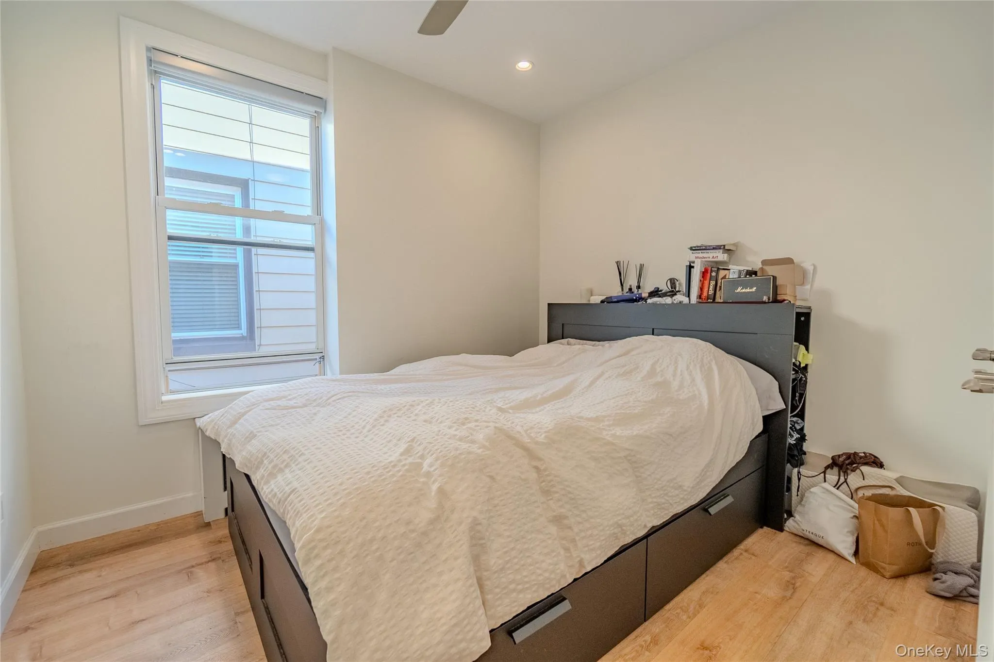 Bedroom featuring light wood-type flooring, recessed lighting, and a ceiling fan Bedroom featuring light wood-type flooring, recessed lighting, and a ceiling fan