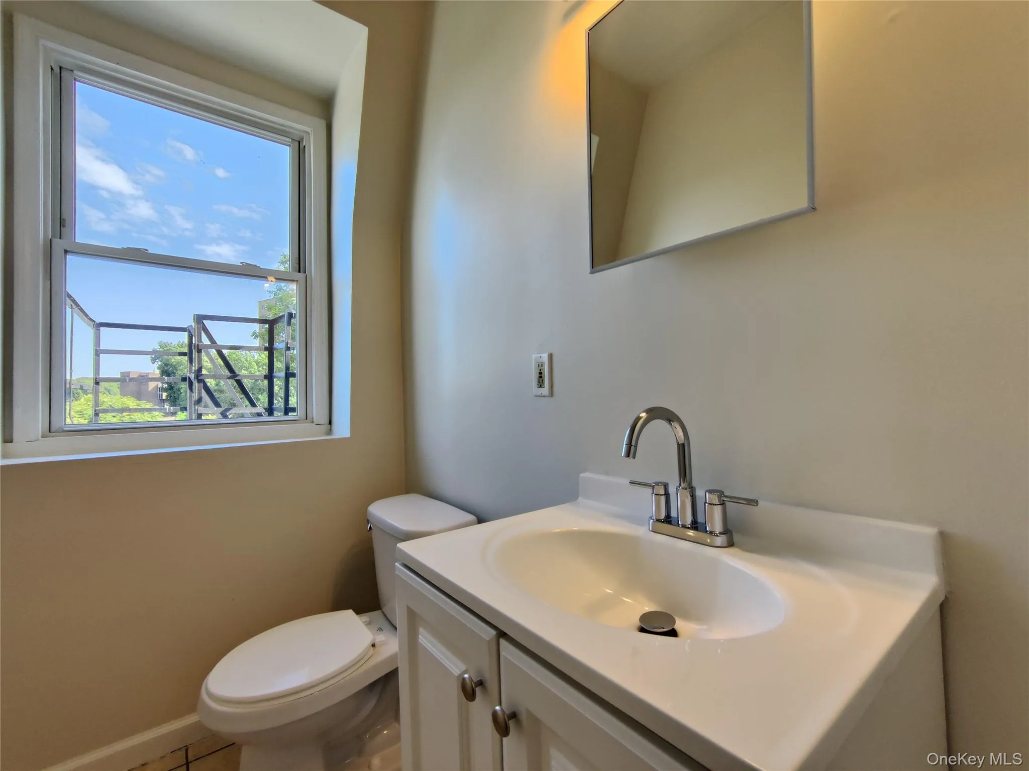 Half bath featuring vanity and tile patterned floors Half bath featuring vanity and tile patterned floors
