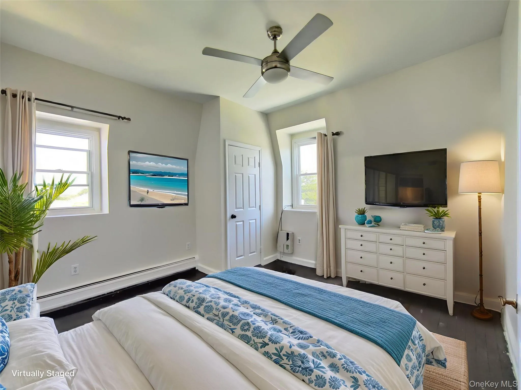 Bedroom featuring baseboard heating, dark wood finished floors, and ceiling fan Bedroom featuring baseboard heating, dark wood finished floors, and ceiling fan