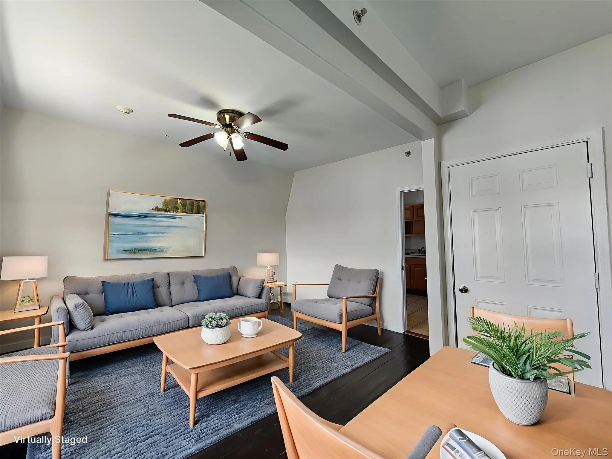 Living area with wood finished floors and a ceiling fan Living area with wood finished floors and a ceiling fan