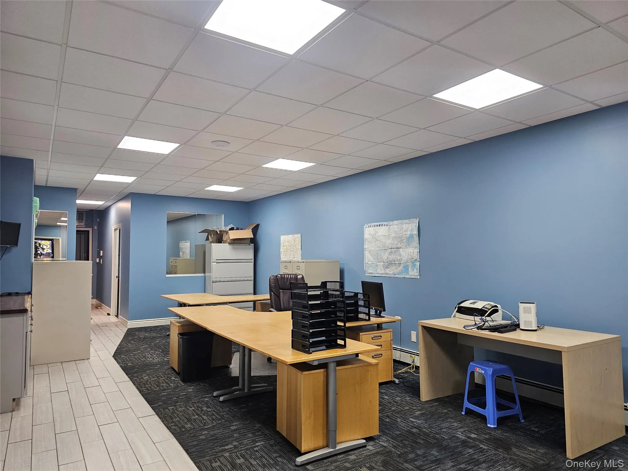 Office featuring a drop ceiling, a baseboard radiator, and dark wood-style flooring Office featuring a drop ceiling, a baseboard radiator, and dark wood-style flooring