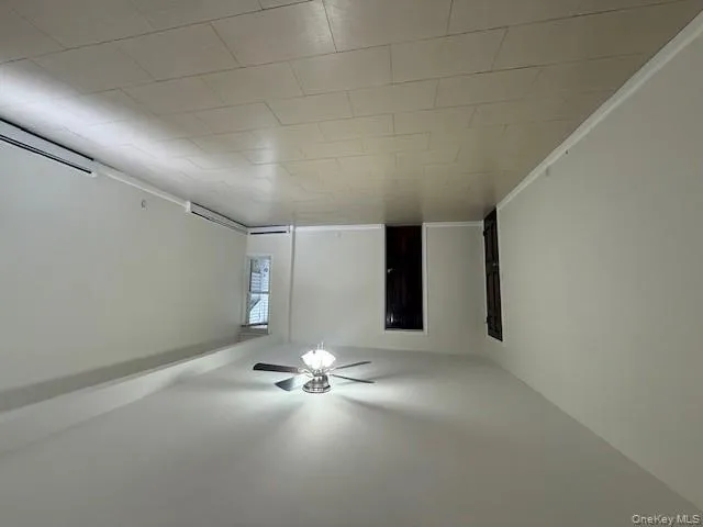 Spare room featuring ceiling fan, baseboard heating, and light tile patterned floors Spare room featuring ceiling fan, baseboard heating, and light tile patterned floors